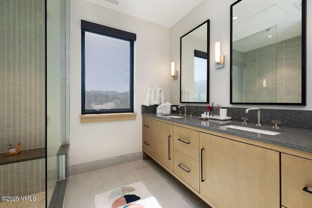 42 Riverfront Ln Unit Th-13, Avon, CO 81620 - bathroom featuring double vanity, tile patterned flooring, tiled shower, and baseboards