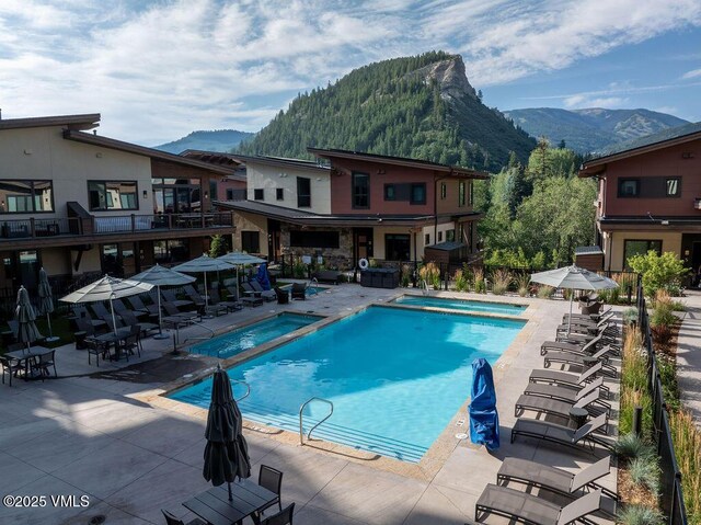 42 Riverfront Ln Unit Th-13, Avon, CO 81620 - community pool with a mountain view and a patio
