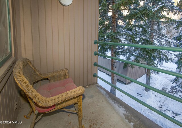 view of snow covered back of property