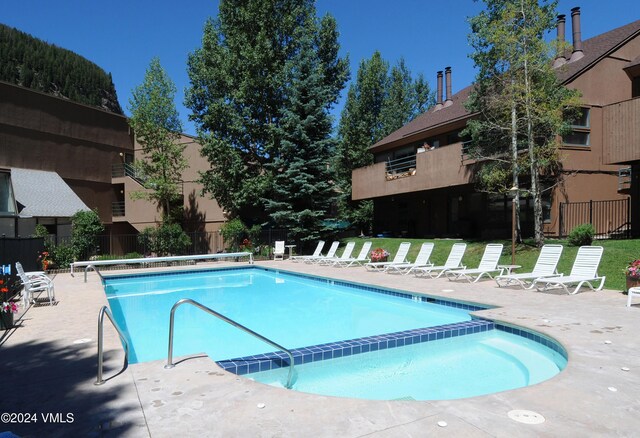 view of swimming pool featuring a patio area