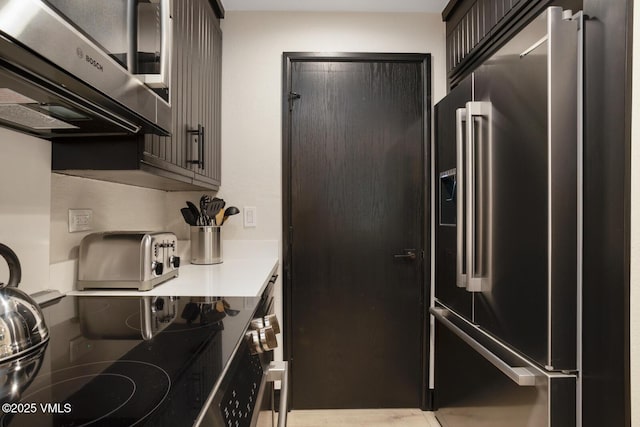 120 Offerson Rd Unit 7320, Beaver Creek, CO 81620 - kitchen featuring high end fridge, stainless steel microwave, light countertops, and range with electric stovetop