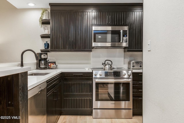 120 Offerson Rd Unit 7320, Beaver Creek, CO 81620 - kitchen featuring stainless steel appliances, light countertops, open shelves, light wood-type flooring, and dark brown cabinets