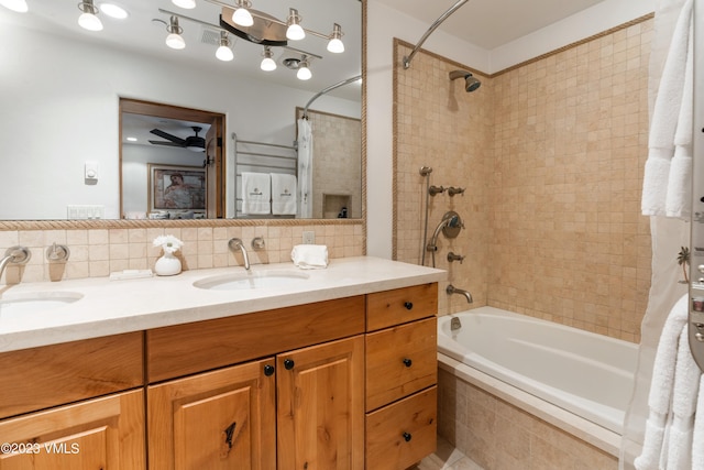 bathroom with tasteful backsplash, shower / bath combo, and vanity