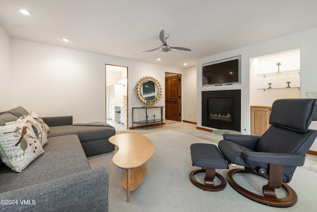 carpeted living room featuring ceiling fan