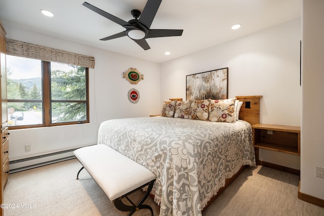 carpeted bedroom with a baseboard radiator and ceiling fan