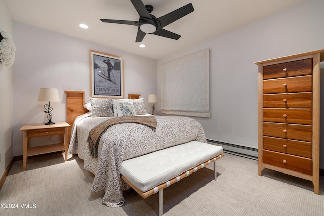 carpeted bedroom with ceiling fan and baseboard heating