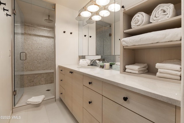 bathroom featuring vanity, tile patterned floors, and walk in shower