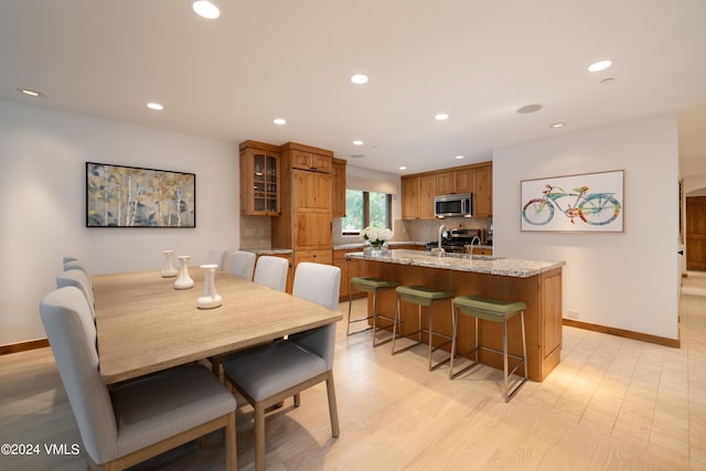 dining room with sink and light hardwood / wood-style flooring