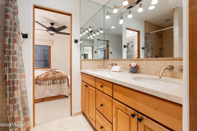 bathroom with tasteful backsplash, ceiling fan, and vanity