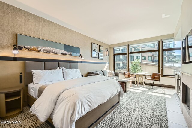 126 Riverfront Ln Unit 345, Avon, CO 81620 - bedroom with a fireplace with flush hearth and tile patterned flooring