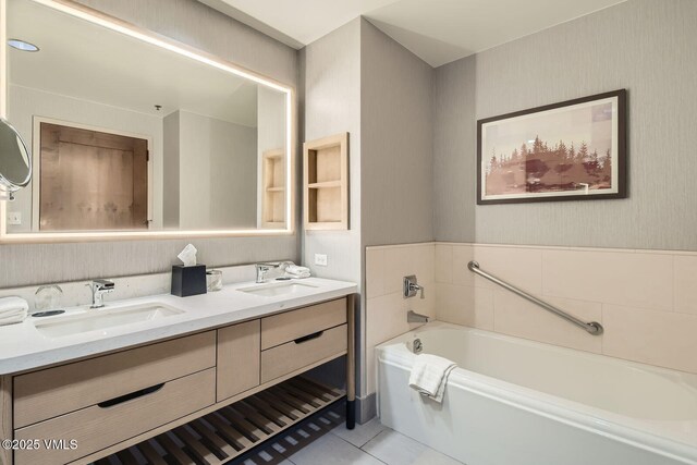126 Riverfront Ln Unit 345, Avon, CO 81620 - bathroom with double vanity, a garden tub, tile patterned flooring, and wallpapered walls