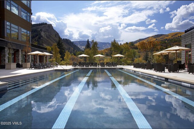 126 Riverfront Ln Unit 345, Avon, CO 81620 - community pool featuring a mountain view and a patio area