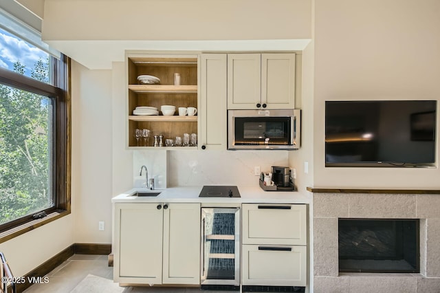 126 Riverfront Ln Unit 345, Avon, CO 81620 - indoor wet bar featuring stainless steel microwave, beverage cooler, light tile patterned floors, and healthy amount of natural light