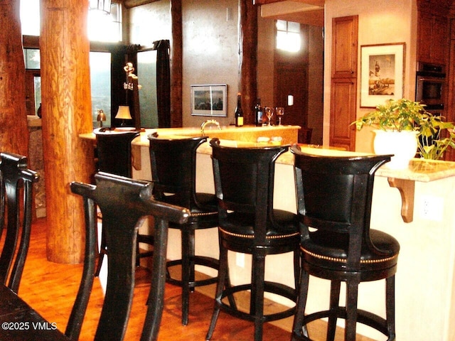 555 Charolais Cir, Edwards, CO 81632 - indoor wet bar featuring wood finished floors and oven