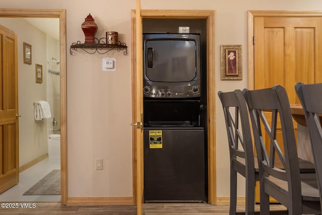 74 Cresta Rd Unit 106, Edwards, CO 81632 - laundry room featuring stacked washing machine and dryer, wood finished floors, and baseboards