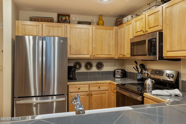 74 Cresta Rd Unit 106, Edwards, CO 81632 - kitchen with appliances with stainless steel finishes, light brown cabinetry, tile countertops, and a sink