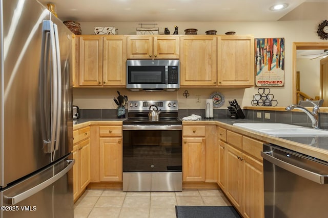 74 Cresta Rd Unit 106, Edwards, CO 81632 - kitchen with stainless steel appliances, a sink, light brown cabinetry, and recessed lighting