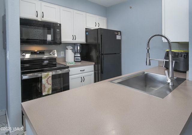127 Jules Dr Unit D-204, Gypsum, CO 81637 - kitchen featuring black appliances, a sink, white cabinetry, and light countertops