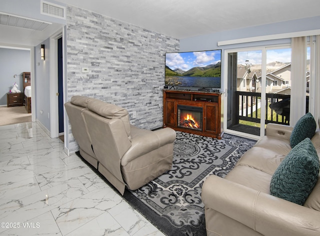 127 Jules Dr Unit D-204, Gypsum, CO 81637 - living area with marble finish flooring and a lit fireplace