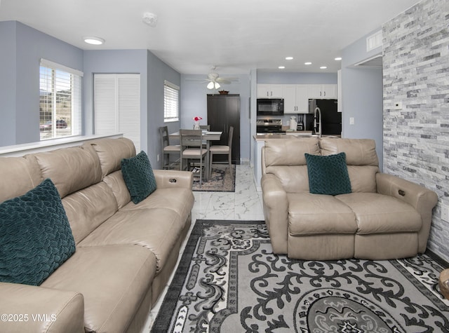 127 Jules Dr Unit D-204, Gypsum, CO 81637 - living area with ceiling fan, plenty of natural light, light marble finish floors, and recessed lighting