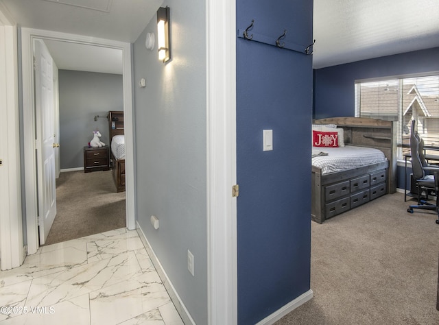 127 Jules Dr Unit D-204, Gypsum, CO 81637 - hallway featuring baseboards, an office area, light marble finish flooring, and light carpet