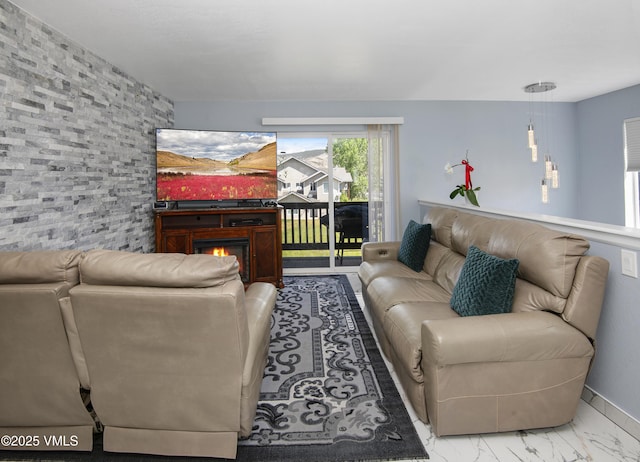 127 Jules Dr Unit D-204, Gypsum, CO 81637 - living room with a lit fireplace and marble finish flooring