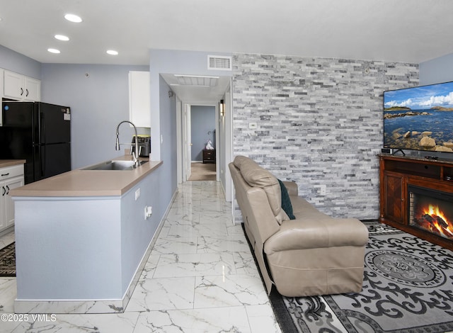 127 Jules Dr Unit D-204, Gypsum, CO 81637 - living area featuring light marble finish floors, recessed lighting, a lit fireplace, and baseboards