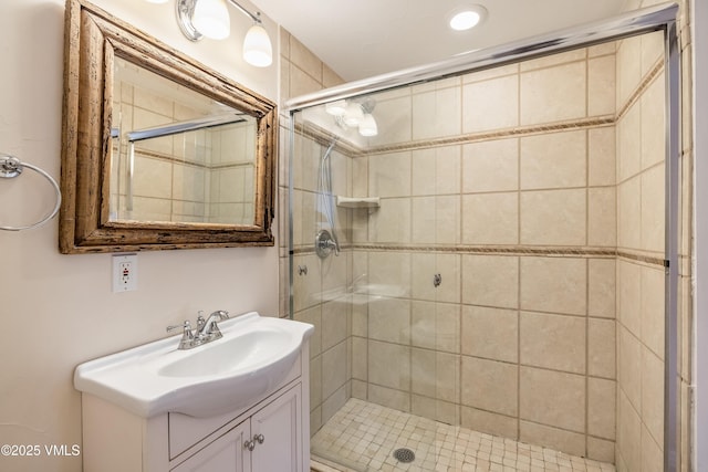 full bath featuring vanity and a shower stall