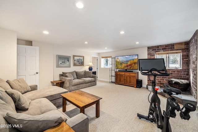 living area with recessed lighting, baseboards, carpet, and brick wall