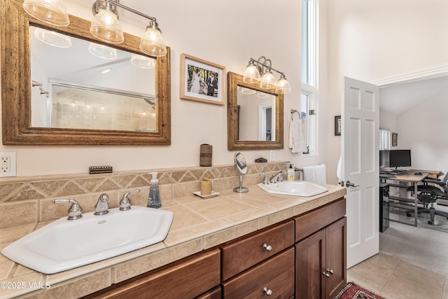 full bathroom featuring tile patterned floors, double vanity, and a sink