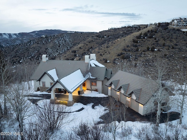 snowy aerial view featuring a mountain view