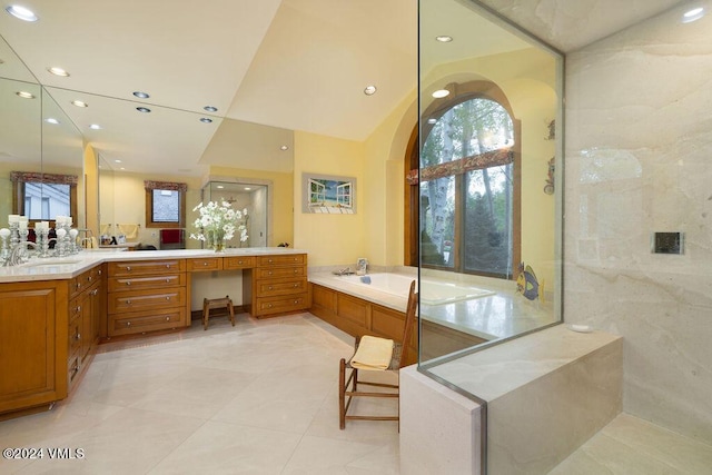 bathroom with independent shower and bath, vanity, lofted ceiling, and tile patterned flooring