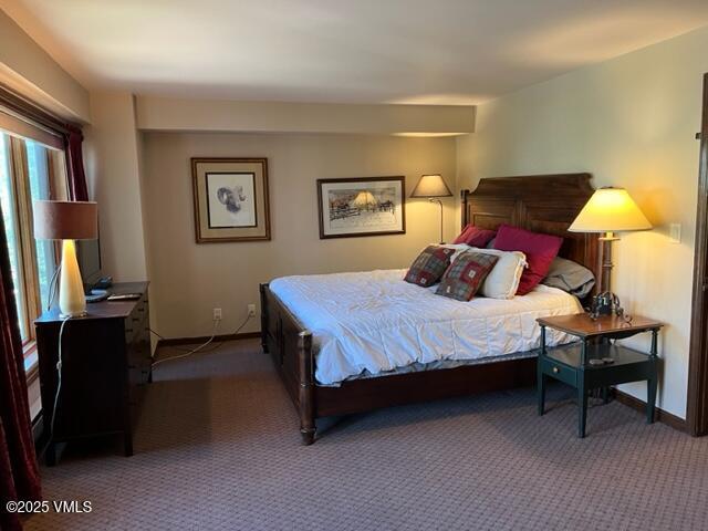 bedroom with baseboards and carpet flooring