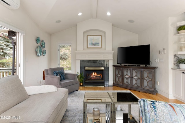 21 Hackamore Rd W, Edwards, CO 81632 - living area with wood finished floors, a wall mounted air conditioner, a premium fireplace, vaulted ceiling, and recessed lighting