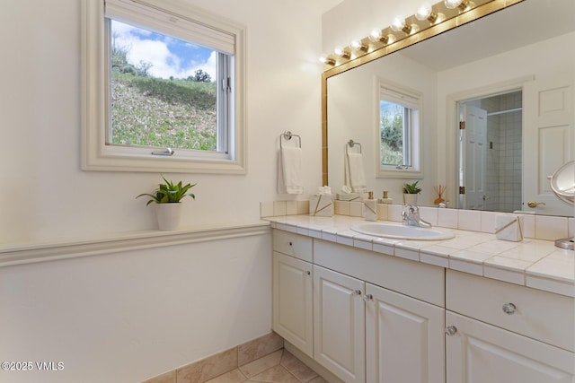 21 Hackamore Rd W, Edwards, CO 81632 - bathroom with vanity, a tile shower, tile patterned flooring, and baseboards
