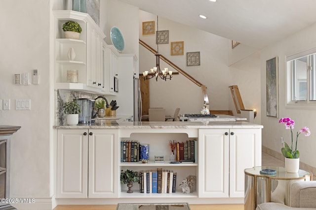 21 Hackamore Rd W, Edwards, CO 81632 - bar area with a chandelier, hanging light fixtures, a sink, vaulted ceiling, and stainless steel refrigerator
