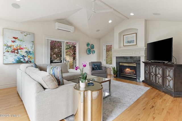 21 Hackamore Rd W, Edwards, CO 81632 - living room featuring a wall unit AC, a ceiling fan, wood finished floors, a high end fireplace, and lofted ceiling