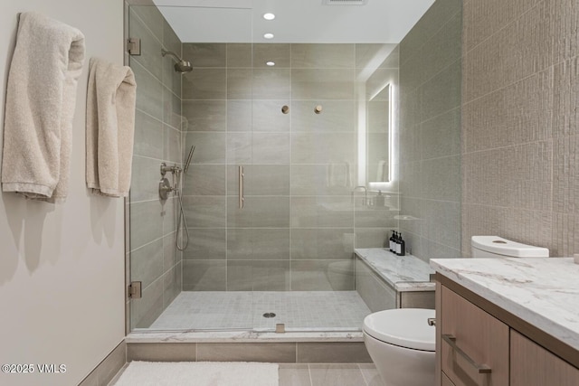 42 Riverfront Ln Unit 104, Avon, CO 81620 - full bathroom featuring a shower stall, vanity, recessed lighting, and tile walls