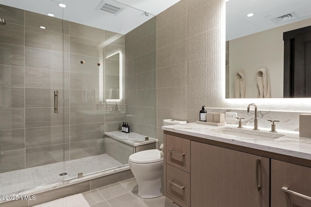 42 Riverfront Ln Unit 104, Avon, CO 81620 - full bathroom featuring vanity, tile walls, and a stall shower