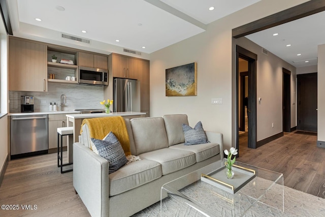42 Riverfront Ln Unit 104, Avon, CO 81620 - living room with light wood-style flooring and recessed lighting