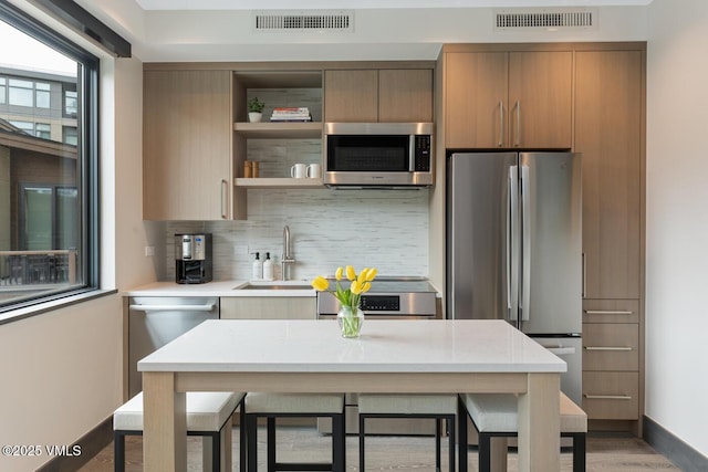 42 Riverfront Ln Unit 104, Avon, CO 81620 - kitchen featuring stainless steel appliances, tasteful backsplash, open shelves, and modern cabinets