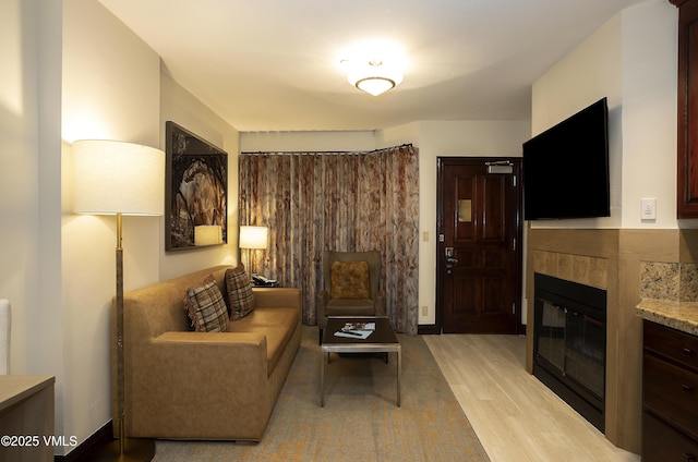 26 Avondale Ln Unit 313-H, Beaver Creek, CO 81620 - living area featuring light wood-style floors and a tiled fireplace