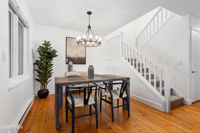 570 Homestead Dr Unit 33, Edwards, CO 81632 - dining room with stairs, a chandelier, light wood-type flooring, and a baseboard heating unit