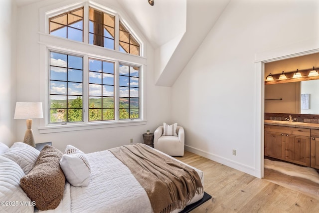 37 Hawley Ct, Edwards, CO 81632 - bedroom with vaulted ceiling, light wood-style flooring, and connected bathroom