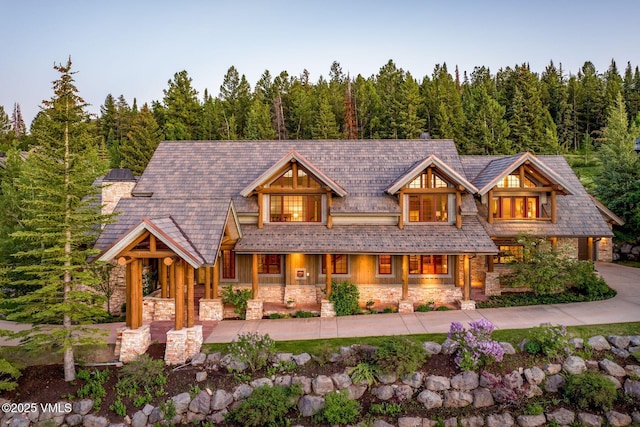 37 Hawley Ct, Edwards, CO 81632 - view of front facade with stone siding, a forest view, and covered porch