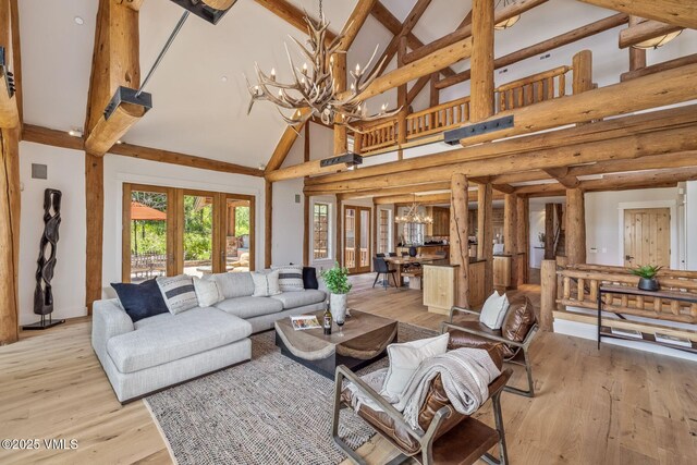 37 Hawley Ct, Edwards, CO 81632 - living area featuring high vaulted ceiling, a chandelier, light wood-style floors, french doors, and beam ceiling
