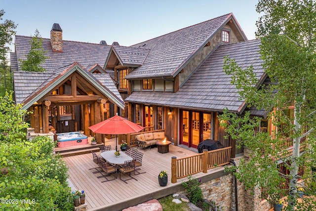 37 Hawley Ct, Edwards, CO 81632 - back of property with a wooden deck, a chimney, outdoor dining space, and an outdoor hangout area