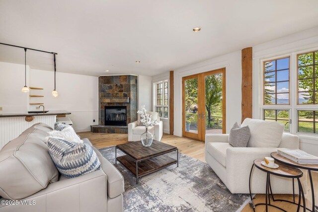 37 Hawley Ct, Edwards, CO 81632 - living room with light wood-style flooring, a fireplace, french doors, and recessed lighting