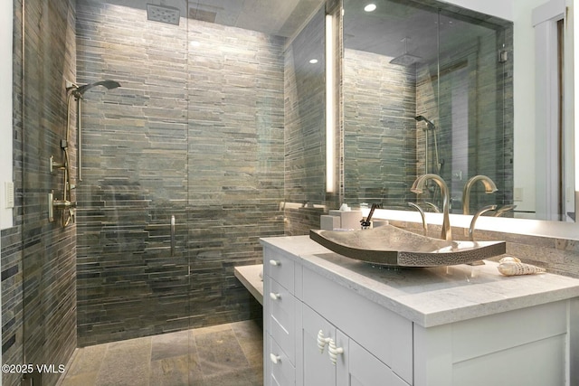 full bathroom featuring tile walls, a shower stall, and vanity