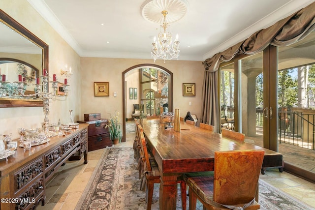 dining space featuring ornamental molding, arched walkways, and stone tile flooring